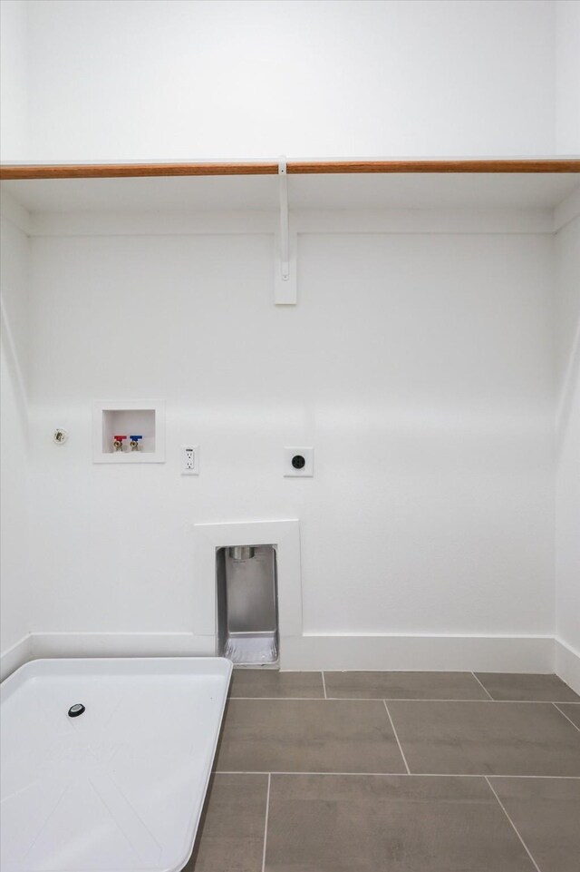 4208 Live Oak St Unit 102, Dallas, TX 75204 - laundry area featuring hookup for an electric dryer, gas dryer hookup, hookup for a washing machine, and dark tile patterned floors