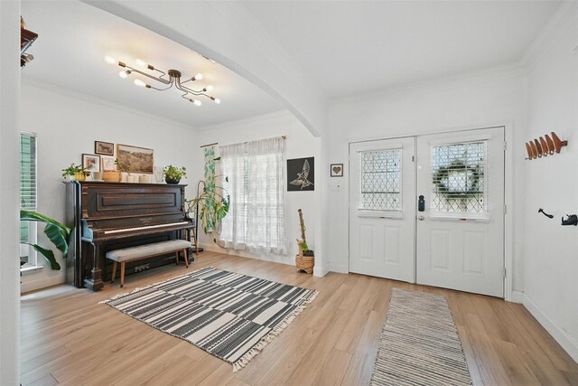 1828 Brown Thrasher Blvd, Savannah, TX 76227 - foyer entrance with ornamental molding, wood finished floors, arched walkways, and a chandelier