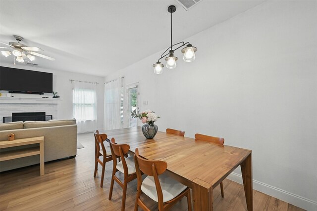 1828 Brown Thrasher Blvd, Savannah, TX 76227 - dining space featuring ceiling fan, a fireplace, and light wood-style floors