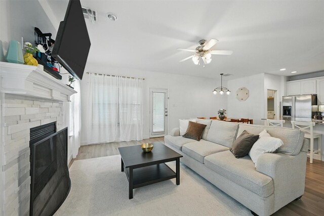 1828 Brown Thrasher Blvd, Savannah, TX 76227 - living area featuring a ceiling fan, light wood-type flooring, a stone fireplace, and recessed lighting