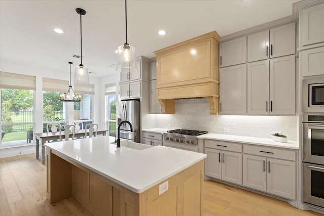 8417 Wembley, The Colony, TX 75056 - kitchen with appliances with stainless steel finishes, decorative backsplash, light wood-style flooring, recessed lighting, and light countertops