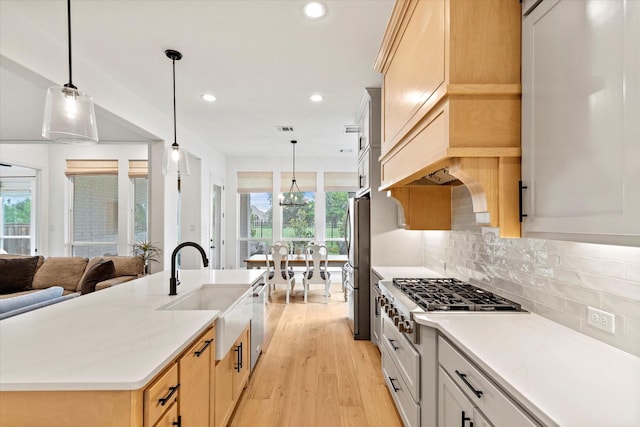 8417 Wembley, The Colony, TX 75056 - kitchen with appliances with stainless steel finishes, recessed lighting, light wood finished floors, tasteful backsplash, and open floor plan
