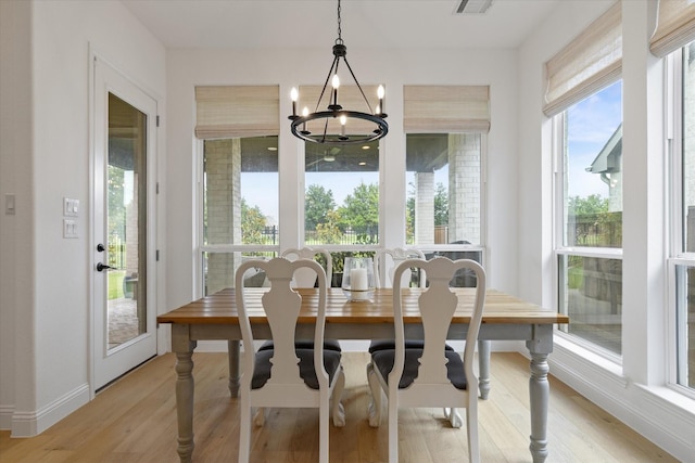 8417 Wembley, The Colony, TX 75056 - dining space featuring light wood-style flooring and a chandelier