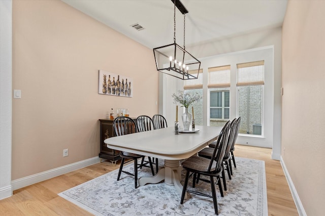 8417 Wembley, The Colony, TX 75056 - dining room featuring a chandelier and light wood-style flooring