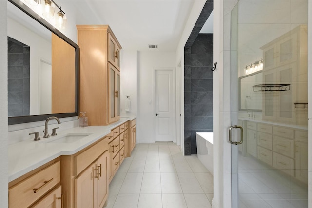 8417 Wembley, The Colony, TX 75056 - bathroom with double vanity, a freestanding tub, tile patterned floors, and a stall shower