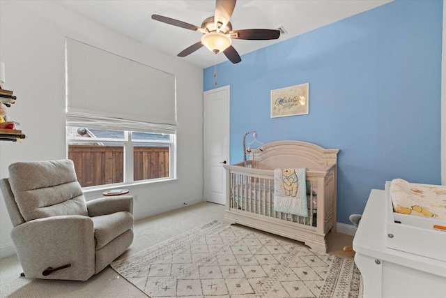 8417 Wembley, The Colony, TX 75056 - carpeted bedroom featuring a nursery area and a ceiling fan