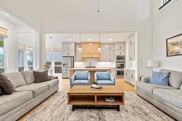 8417 Wembley, The Colony, TX 75056 - living room with light wood finished floors and a high ceiling