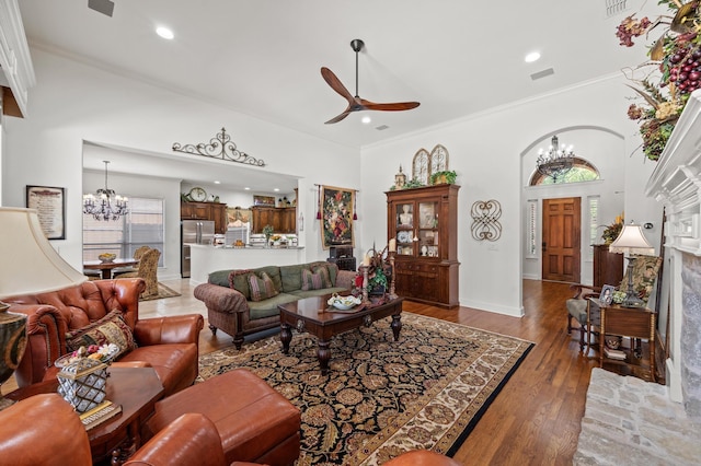 4896 Corinthian Bay Dr, Frisco, TX 75034 - living room featuring a chandelier, a ceiling fan, ornamental molding, wood finished floors, and recessed lighting