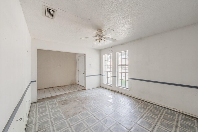3922 Greenway Dr, Garland, TX 75041 - spare room featuring a ceiling fan and a textured ceiling