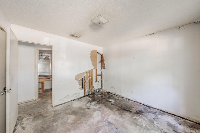 3922 Greenway Dr, Garland, TX 75041 - unfurnished room with concrete flooring and a textured ceiling