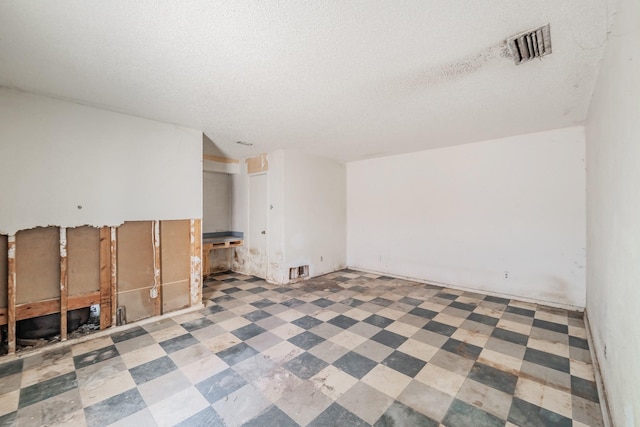 3922 Greenway Dr, Garland, TX 75041 - spare room with a textured ceiling