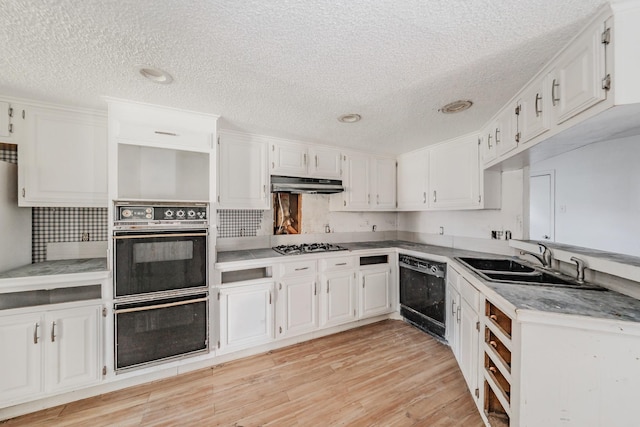 3922 Greenway Dr, Garland, TX 75041 - kitchen featuring black appliances, under cabinet range hood, a textured ceiling, white cabinets, and light wood-style floors