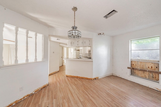 3922 Greenway Dr, Garland, TX 75041 - unfurnished living room with light wood finished floors and baseboards