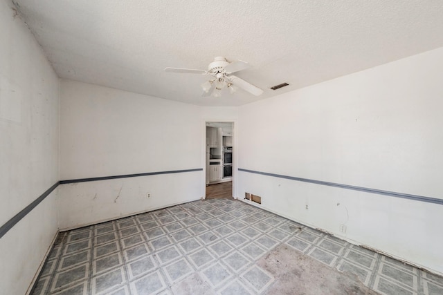 3922 Greenway Dr, Garland, TX 75041 - empty room with ceiling fan and a textured ceiling