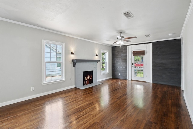 3620 Stadium Dr, Fort Worth, TX 76109 - unfurnished living room featuring healthy amount of natural light, ornamental molding, a lit fireplace, ceiling fan, and wood finished floors