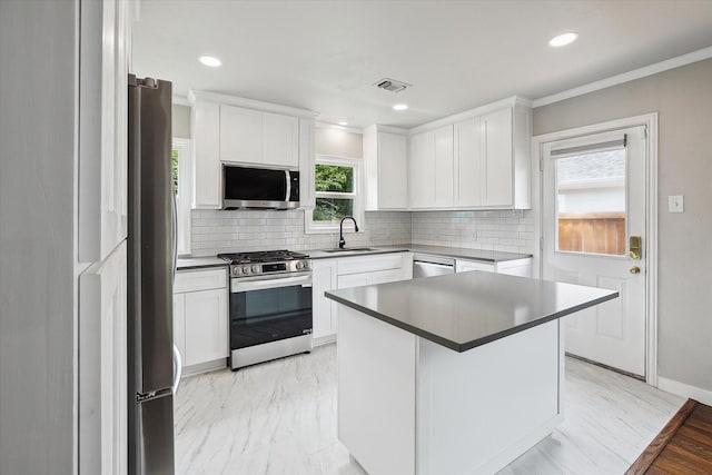 3620 Stadium Dr, Fort Worth, TX 76109 - kitchen featuring appliances with stainless steel finishes, decorative backsplash, white cabinets, ornamental molding, and recessed lighting