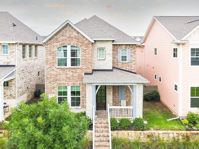 8849 Redding St, North Richland Hills, TX 76180 - view of front of home with a shingled roof, covered porch, brick siding, and stone siding