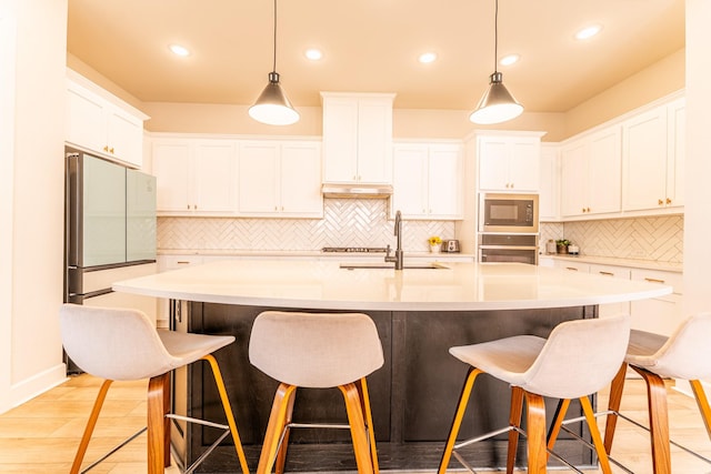 8849 Redding St, North Richland Hills, TX 76180 - kitchen with black microwave, oven, backsplash, a kitchen breakfast bar, and recessed lighting