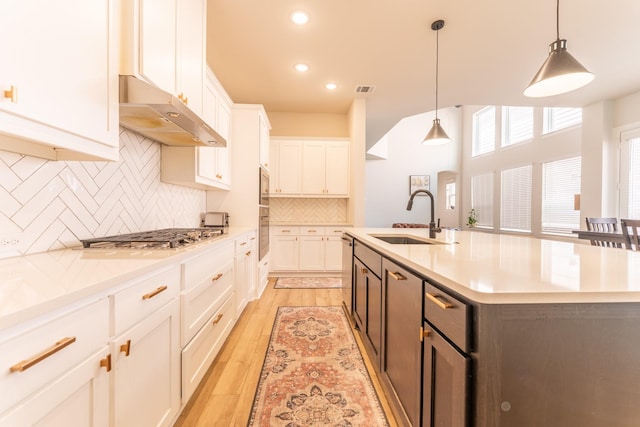 8849 Redding St, North Richland Hills, TX 76180 - kitchen with stainless steel appliances, under cabinet range hood, white cabinetry, light countertops, and recessed lighting