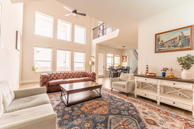 8849 Redding St, North Richland Hills, TX 76180 - living room featuring stairs, wood finished floors, a ceiling fan, and a towering ceiling