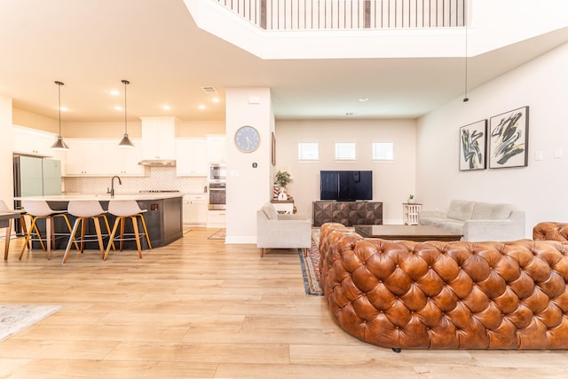 8849 Redding St, North Richland Hills, TX 76180 - living room with light wood-style flooring, recessed lighting, and a towering ceiling