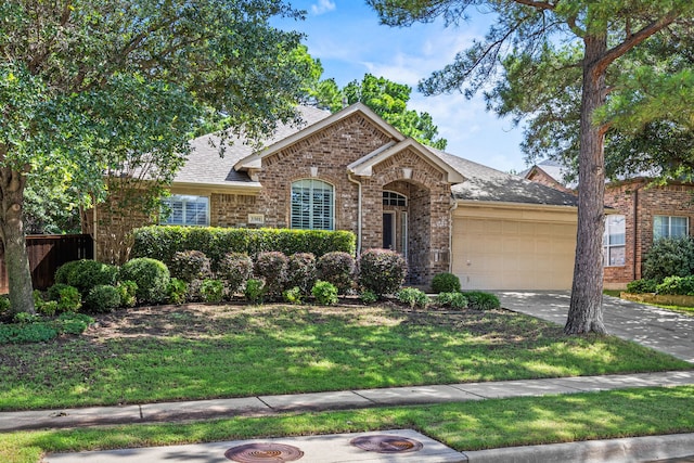 3301 Marymount Dr, Denton, TX 76210 - view of front of property featuring brick siding, an attached garage, concrete driveway, and a shingled roof