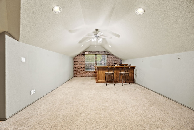 3301 Marymount Dr, Denton, TX 76210 - bonus room with vaulted ceiling, a textured ceiling, carpet, a ceiling fan, and a bar