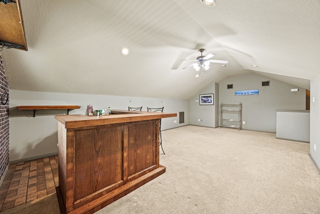 3301 Marymount Dr, Denton, TX 76210 - indoor dry bar featuring vaulted ceiling, light carpet, a ceiling fan, and a textured ceiling