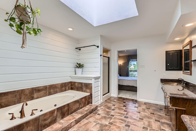 2202 Southern Ct, Carrollton, TX 75006 - full bath with a skylight, a shower stall, a whirlpool tub, vanity, and stone finish floors
