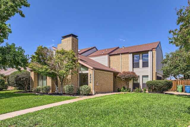 2202 Southern Ct, Carrollton, TX 75006 - view of front of house with a chimney, brick siding, and a shingled roof