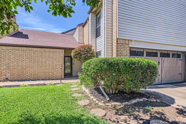 2202 Southern Ct, Carrollton, TX 75006 - view of property exterior with brick siding, a garage, and a yard
