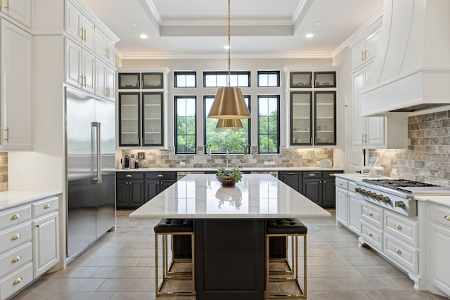 5724 Bellaria Ct, Flower Mound, TX 75022 - kitchen featuring built in fridge, premium range hood, gas stovetop, a breakfast bar area, and ornamental molding