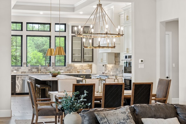 5724 Bellaria Ct, Flower Mound, TX 75022 - dining room with healthy amount of natural light, crown molding, light wood finished floors, recessed lighting, and a chandelier
