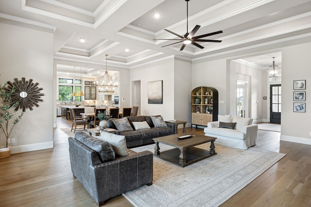 5724 Bellaria Ct, Flower Mound, TX 75022 - living room with a chandelier, wood finished floors, ceiling fan, ornamental molding, and coffered ceiling