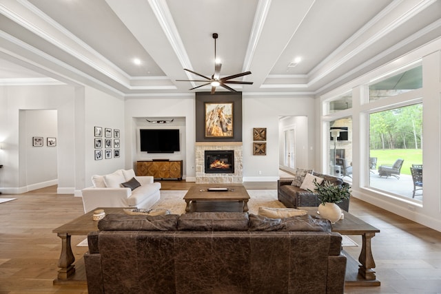 5724 Bellaria Ct, Flower Mound, TX 75022 - living room featuring a stone fireplace, wood finished floors, ceiling fan, ornamental molding, and coffered ceiling