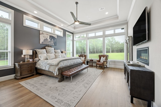 5724 Bellaria Ct, Flower Mound, TX 75022 - bedroom featuring light wood-style floors, multiple windows, crown molding, a raised ceiling, and recessed lighting