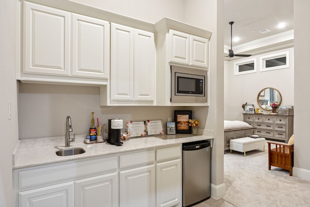 5724 Bellaria Ct, Flower Mound, TX 75022 - kitchen with stainless steel microwave, fridge, light carpet, white cabinets, and ceiling fan