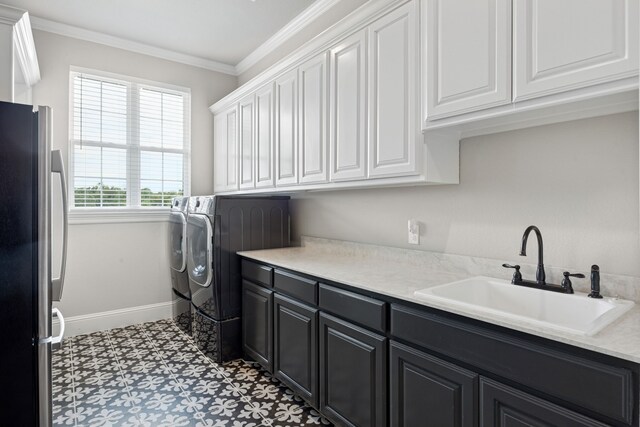 5724 Bellaria Ct, Flower Mound, TX 75022 - washroom with washer and clothes dryer, cabinet space, ornamental molding, and light flooring