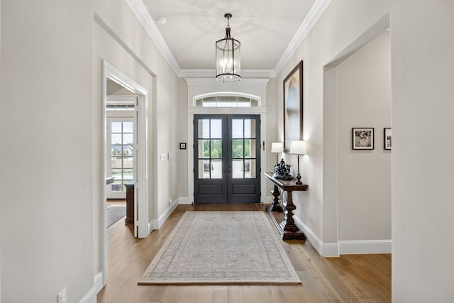 5724 Bellaria Ct, Flower Mound, TX 75022 - entryway featuring french doors, wood finished floors, crown molding, and a chandelier