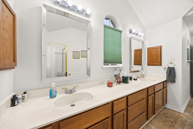 2918 Beau Dr, Mesquite, TX 75181 - full bathroom with vaulted ceiling, double vanity, and a shower