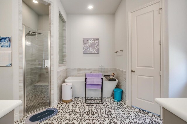 5729 Violet Crown Pl, Fort Worth, TX 76126 - bathroom with a shower stall, vanity, a freestanding tub, tile walls, and tile patterned flooring