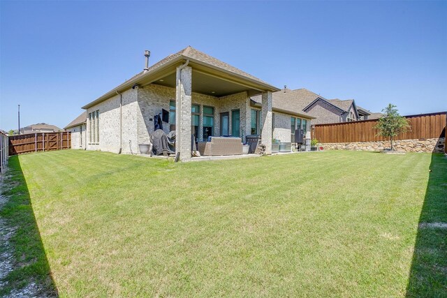 5729 Violet Crown Pl, Fort Worth, TX 76126 - back of house featuring a fenced backyard, brick siding, and a patio