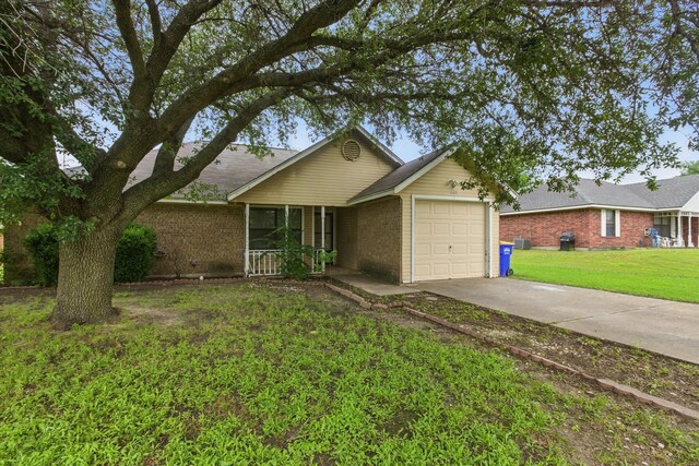 220 Brook Cir, Krum, TX 76249 - single story home featuring an attached garage, brick siding, driveway, and a front yard