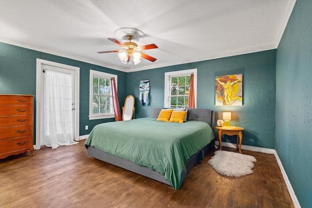 425 W Belden St, Sherman, TX 75092 - bedroom with a textured wall, multiple windows, wood finished floors, ornamental molding, and a ceiling fan