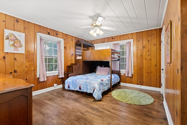 425 W Belden St, Sherman, TX 75092 - bedroom featuring wood finished floors, wooden walls, and ceiling fan