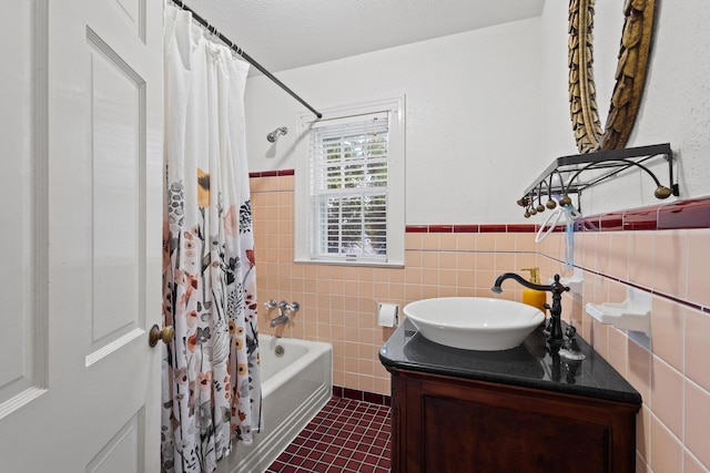 425 W Belden St, Sherman, TX 75092 - full bathroom with tile walls, vanity, tile patterned flooring, shower / bath combo, and wainscoting