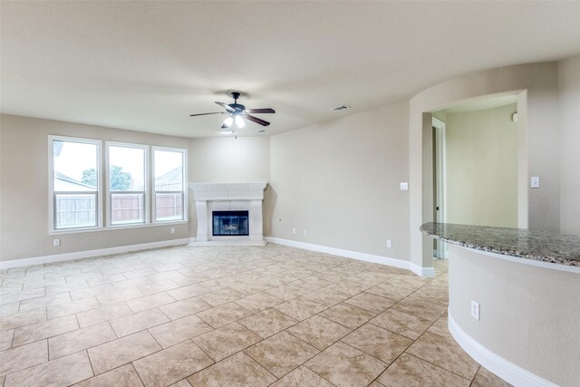 302 Shire Ln, Celina, TX 75009 - unfurnished living room featuring a ceiling fan, a glass covered fireplace, and light tile patterned flooring