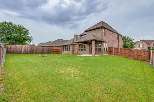 302 Shire Ln, Celina, TX 75009 - rear view of house featuring brick siding, a fenced backyard, a patio, and a chimney