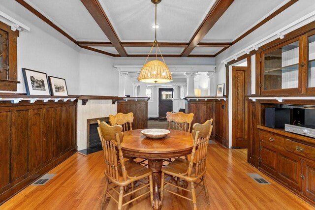 1600 S Adams St, Fort Worth, TX 76104 - dining room featuring light wood-type flooring, coffered ceiling, decorative columns, wainscoting, and beam ceiling