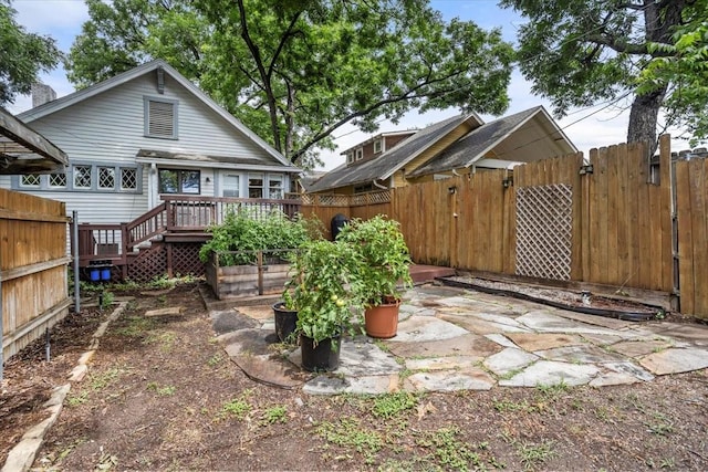 1600 S Adams St, Fort Worth, TX 76104 - back of property featuring a fenced backyard, a deck, a gate, and a patio area